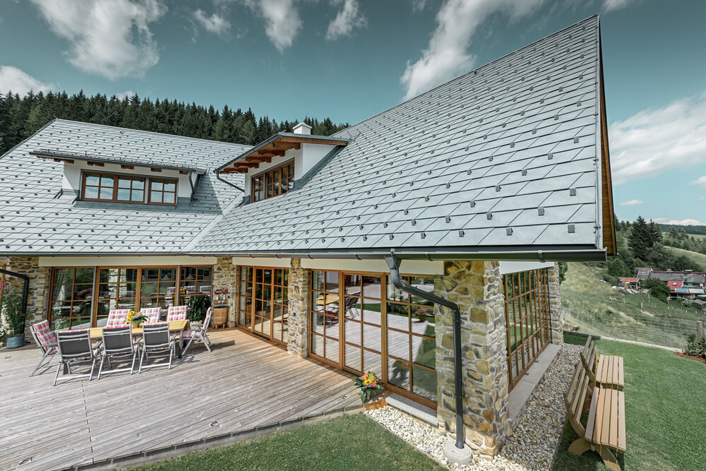 Maison individuelle recouverte de bardeaux de toiture PREFA couleur P.10 gris pierre