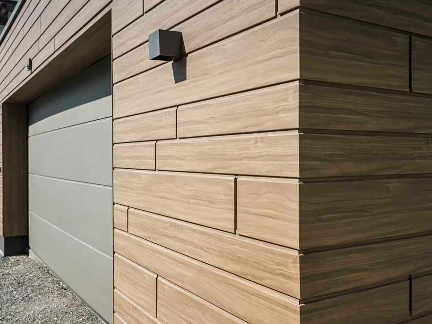 Close-up van een garage bekleed met PREFA sidings met houteffect. Als kleur werd notenbruin gekozen.