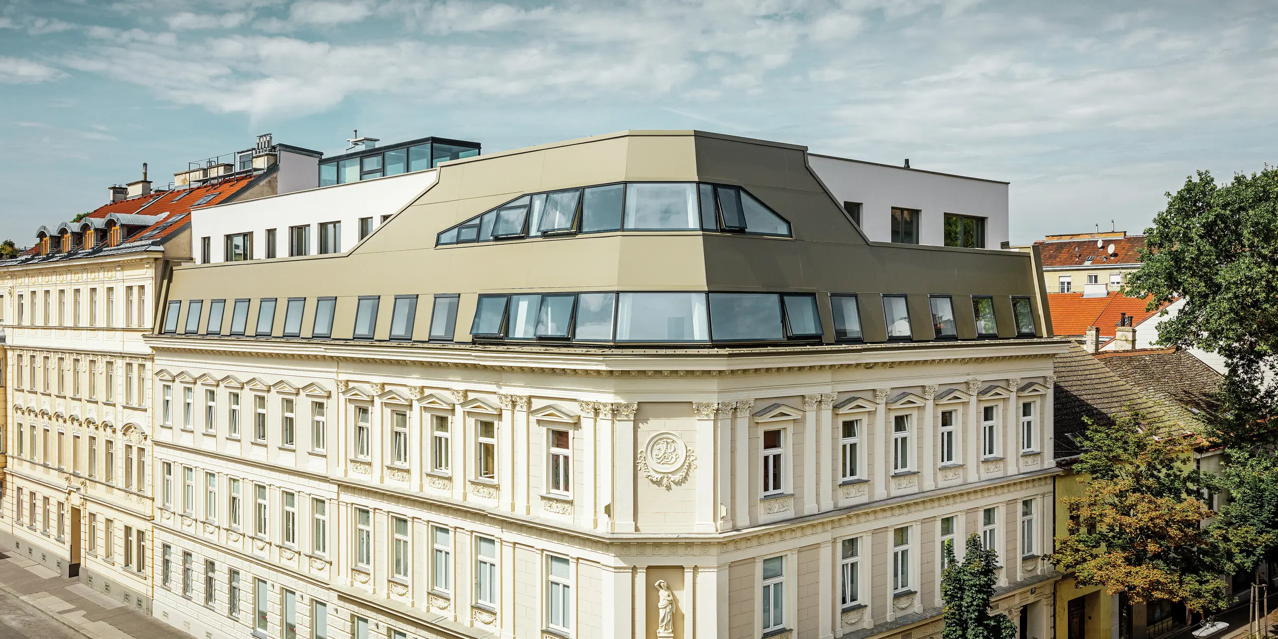 Dakuitbreiding in de Schloßhofer Straße in Wenen met bronskleurige aluminium composietplaten van PREFA