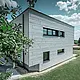 Vue latérale d’une maison individuelle moderne, avec façade en Siding.X visible.