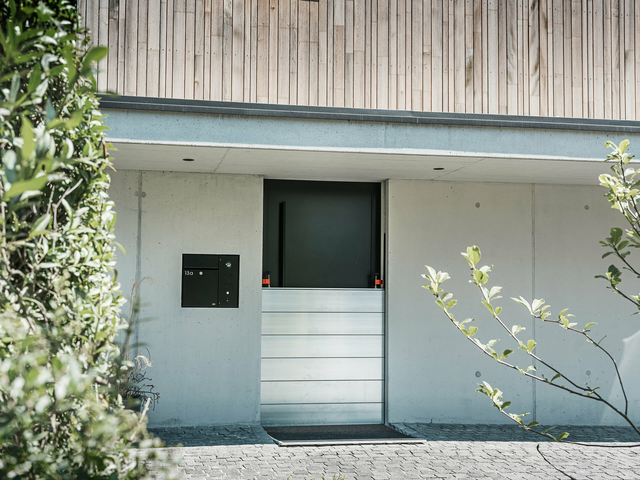 Sur cette photo nous pouvons voir la protection contre les crues PREFA protégeant l'entrée d'une maison.