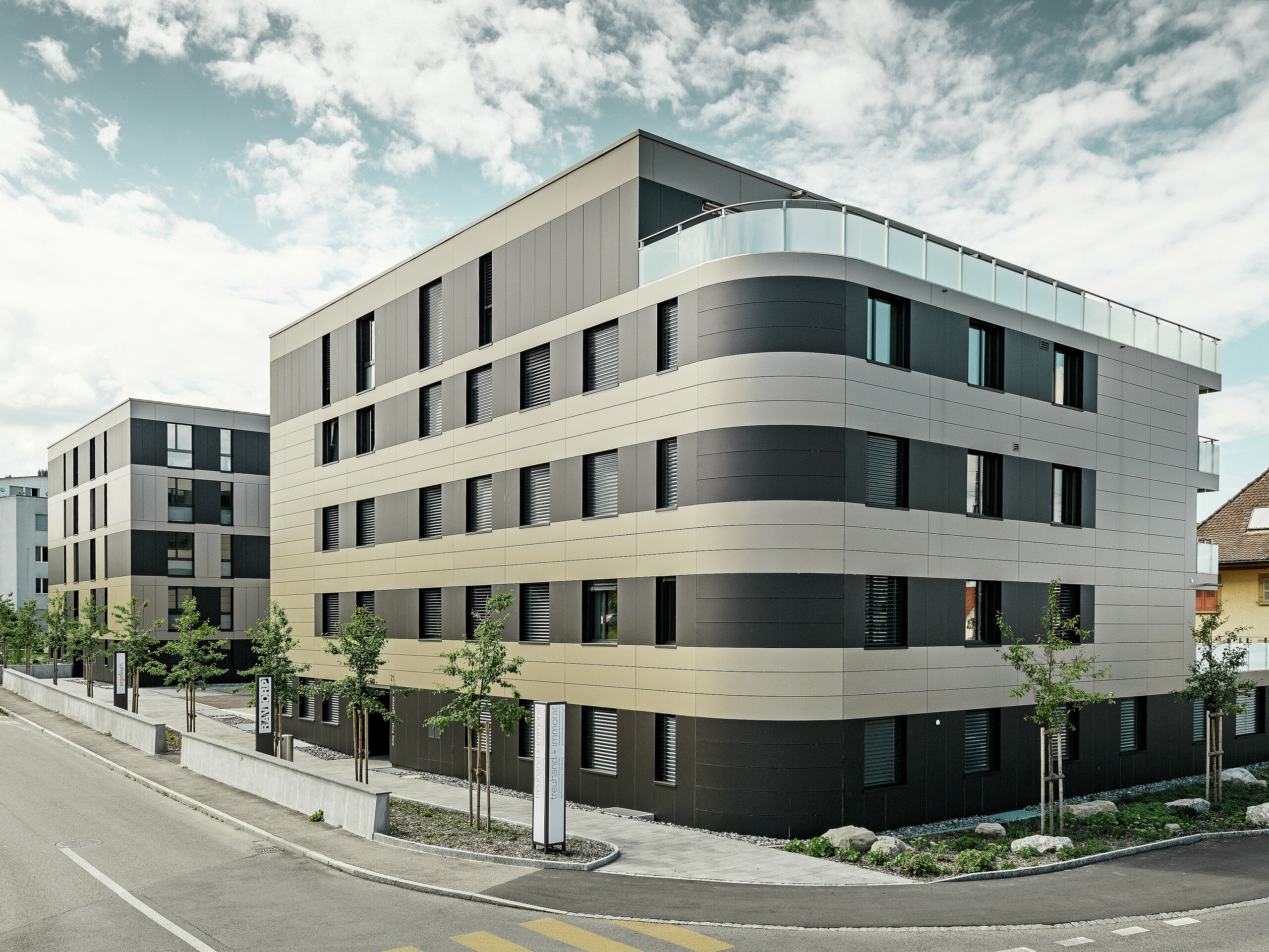 Kubusvormig woongebouw met aluminiumgevel in brons en zwartgrijze elementen