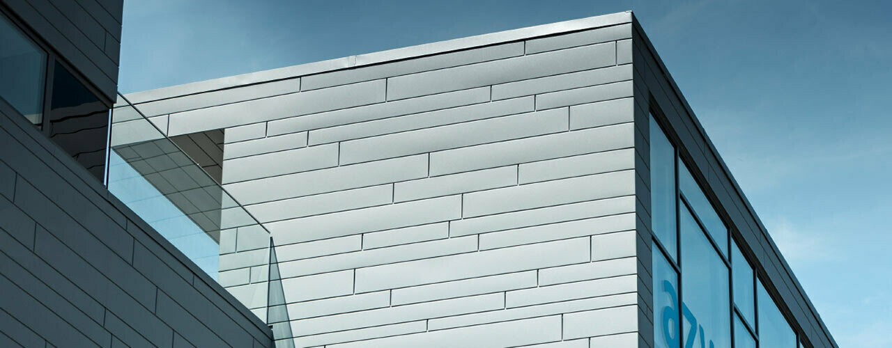 Sur cette façade extérieure, les Sidings PREFA couleur P.10 gris souris ont été combinés en différentes longueurs et largeurs.