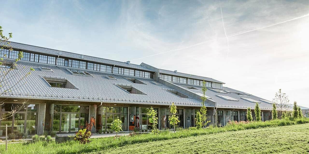 De nieuw gerenoveerde Panzerhalle in Salzburg met veel bedrijfsvestigingen en een nieuw PREFA dak in zilvermetallic